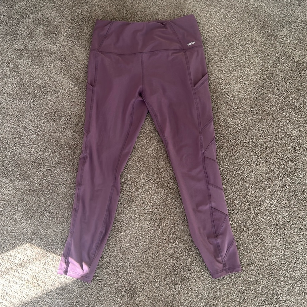 Purple workout leggings with a side pocket. RBX. Size M